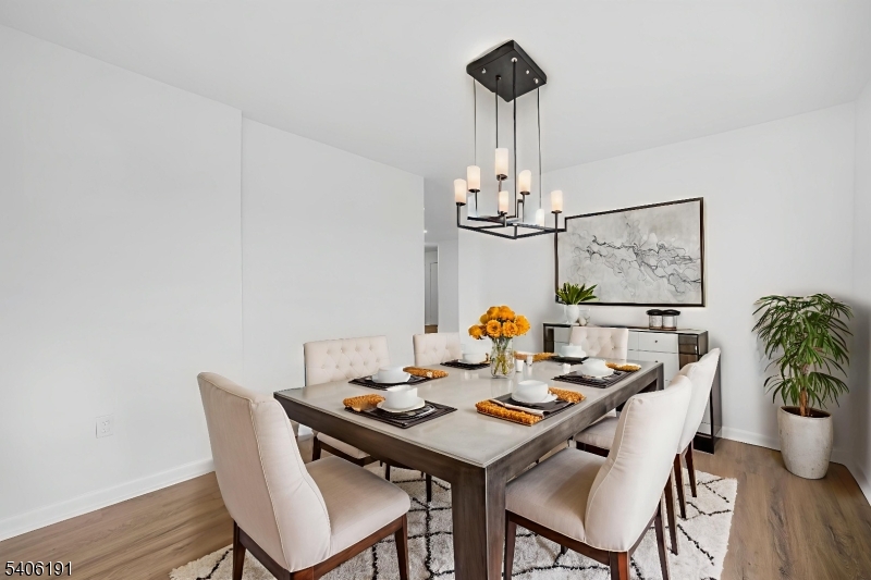 850 Main Street, Unit 3F Hackensack, NJ 07601 - Photo 6 of 11 a view of a dining room with furniture wooden floor and chandelier