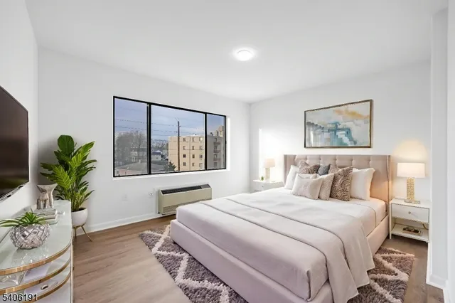 a bedroom with a large bed and a potted plant