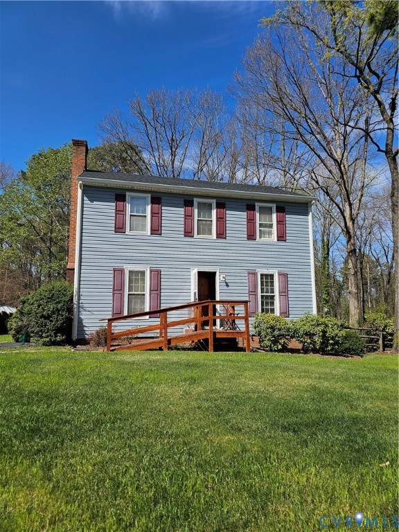 8996 Tameo Road Glen Allen, VA 23060 - Photo 2 of 45 a front view of a house with a garden and trees