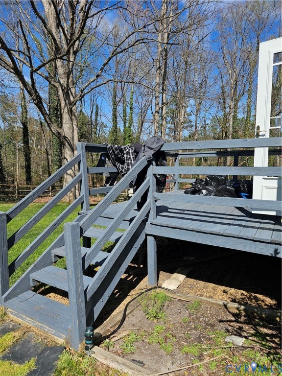 8996 Tameo Road Glen Allen, VA 23060 - Photo 9 of 45 a roof deck with wooden floor and fence next to a yard