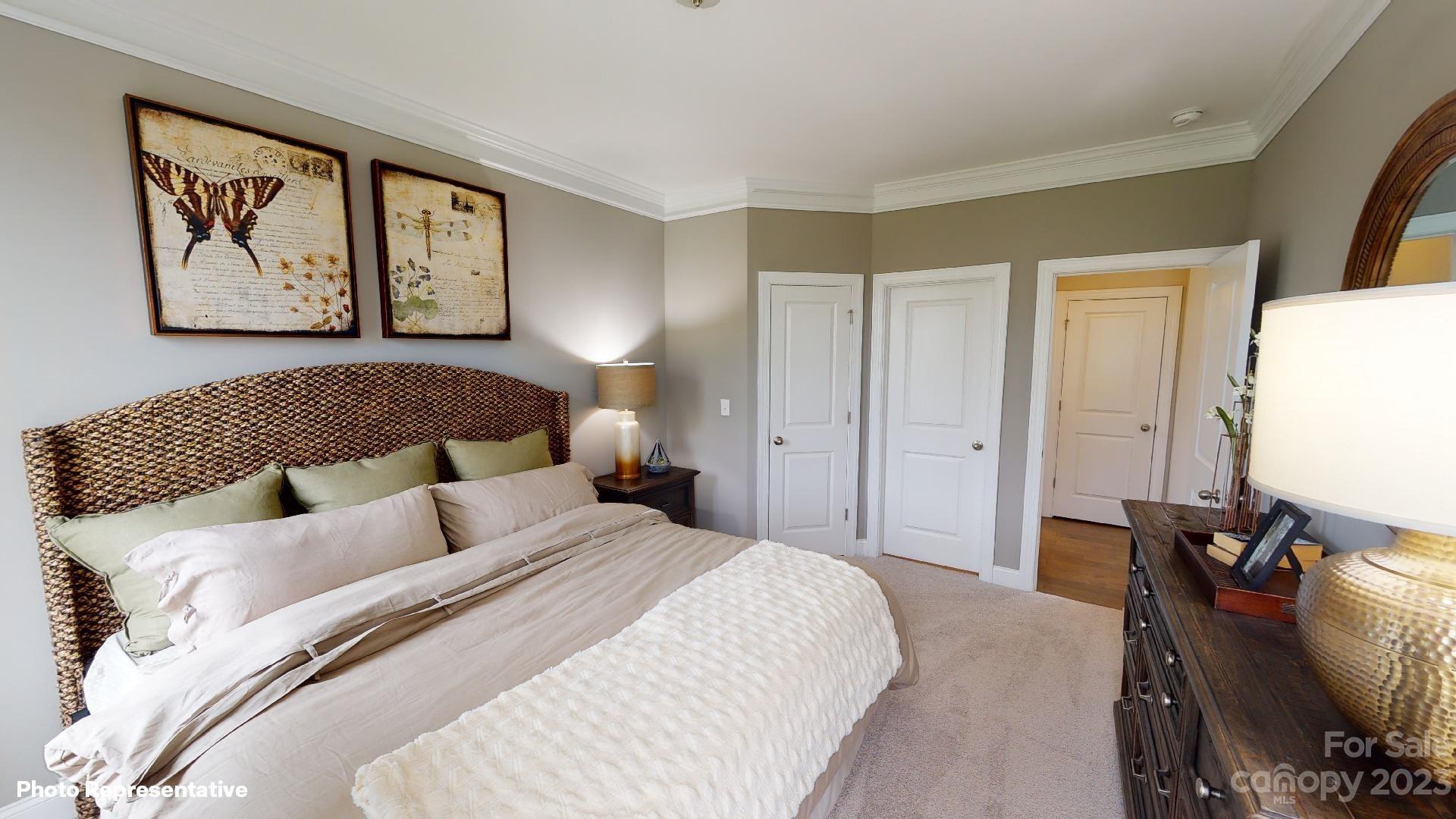 384 Streamwood Road Troutman, NC 28166 - Photo 14 of 36 a bedroom with bed and a painting on the wall