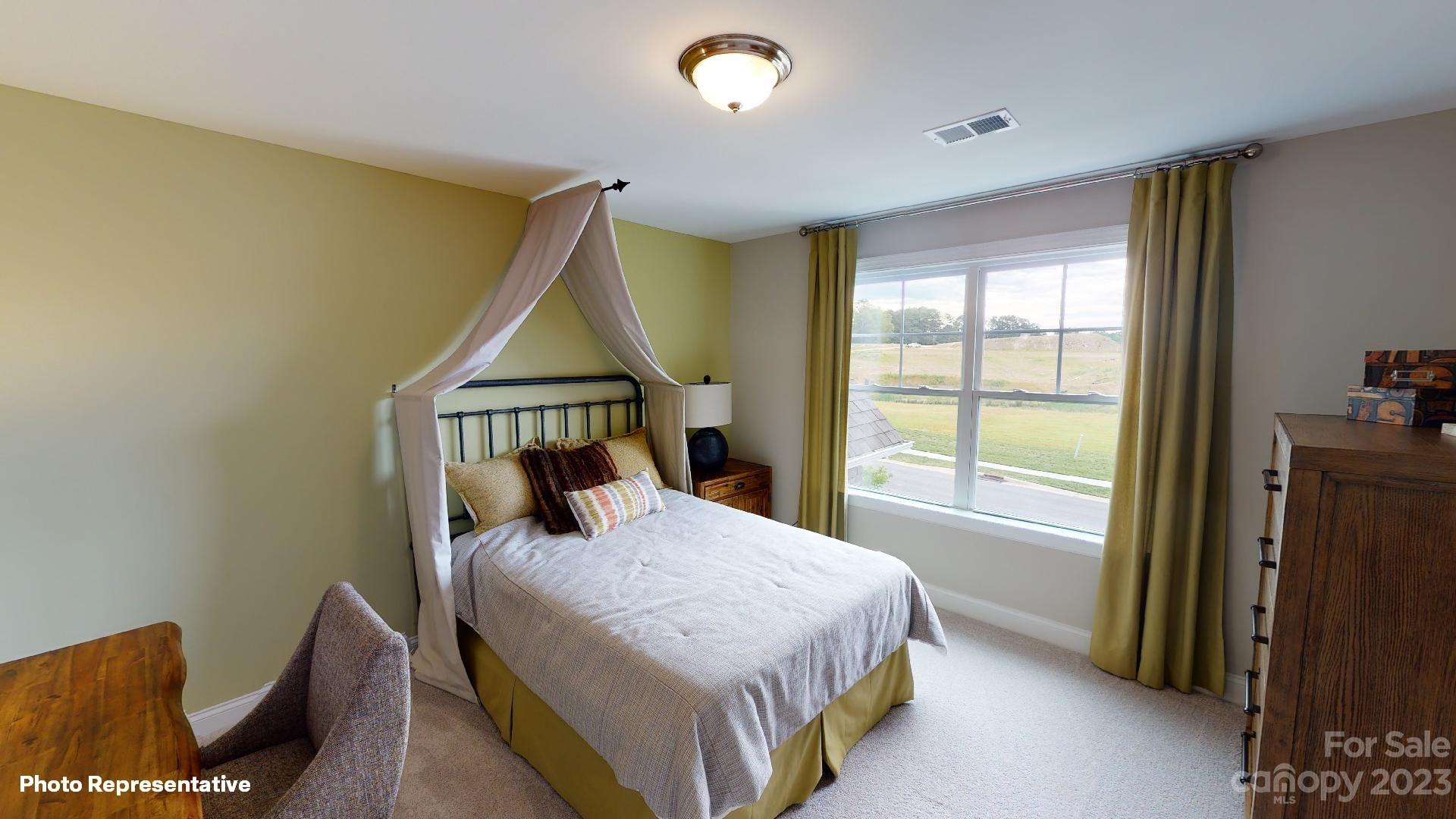 384 Streamwood Road Troutman, NC 28166 - Photo 18 of 36 a bedroom with a bed window and a potted plant
