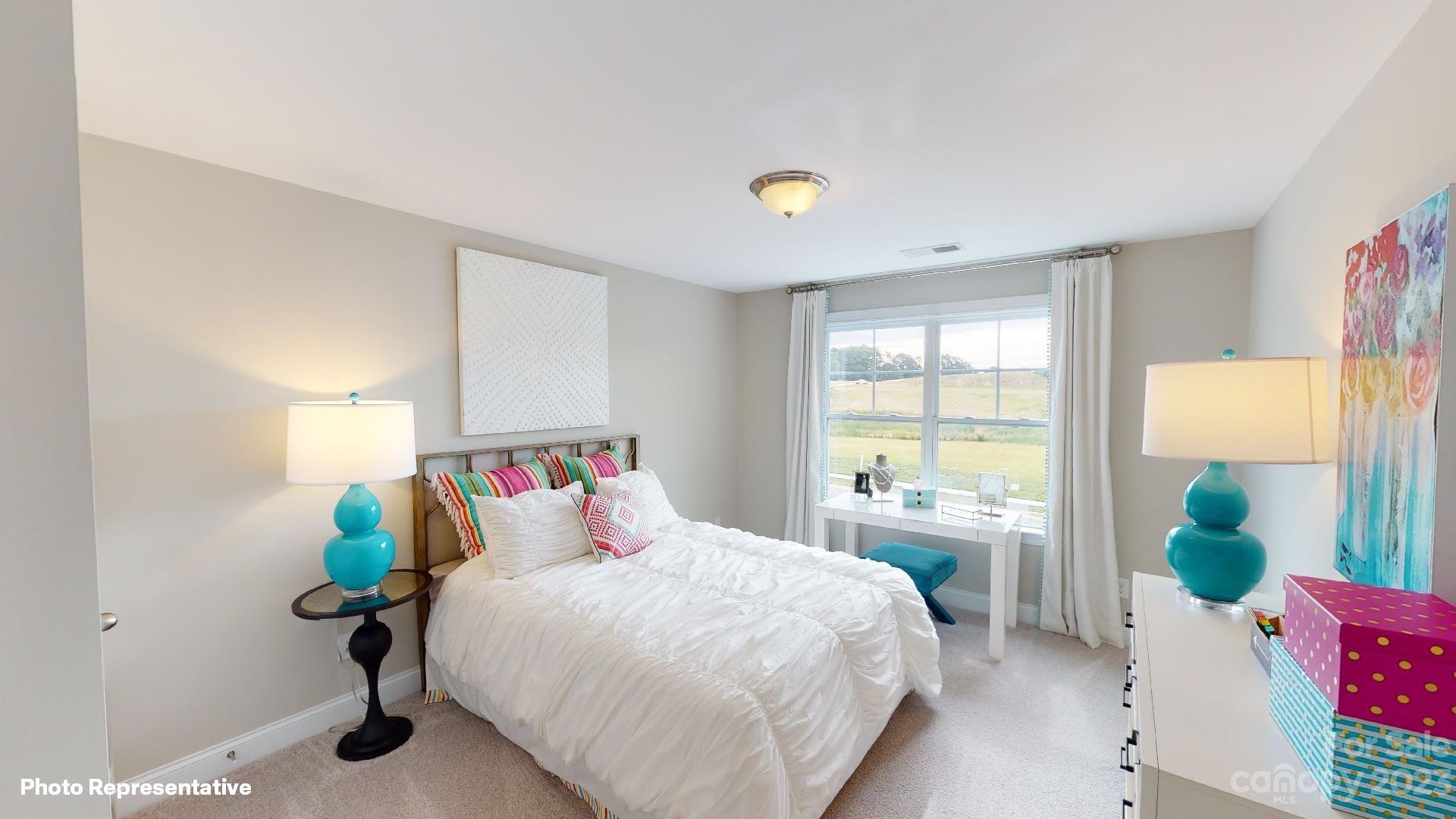 384 Streamwood Road Troutman, NC 28166 - Photo 20 of 36 a bedroom with a bed and a large window