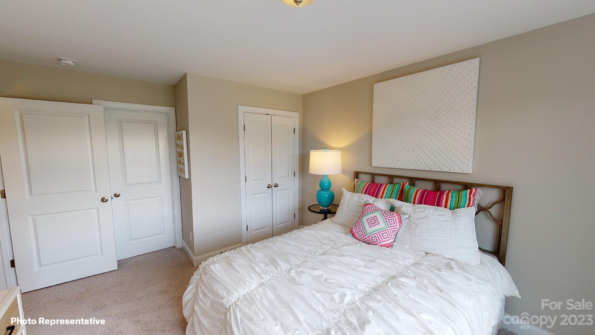 384 Streamwood Road Troutman, NC 28166 - Photo 21 of 36 a bedroom with a bed and closet