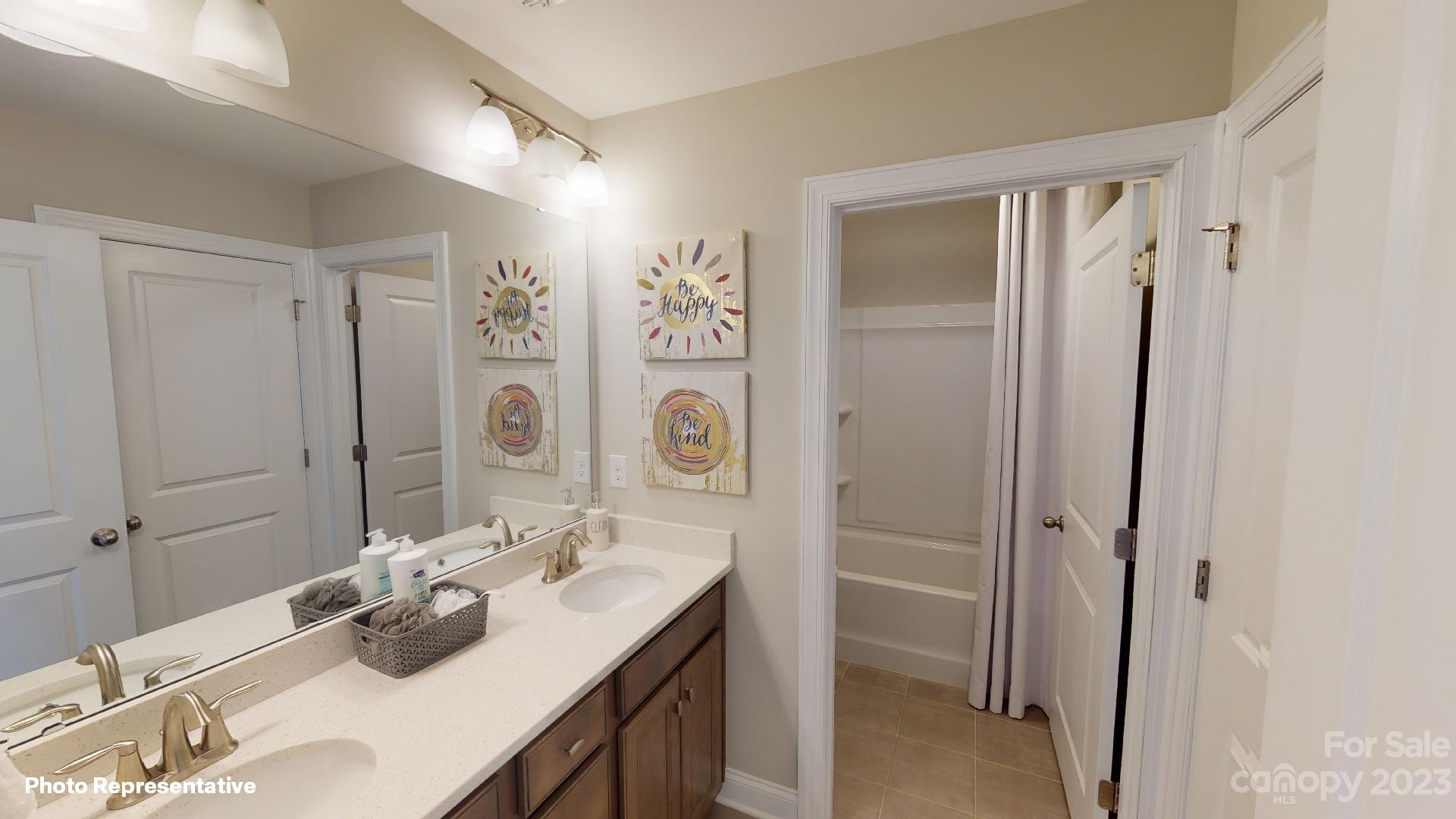 384 Streamwood Road Troutman, NC 28166 - Photo 22 of 36 a bathroom with a double vanity sink mirror and double