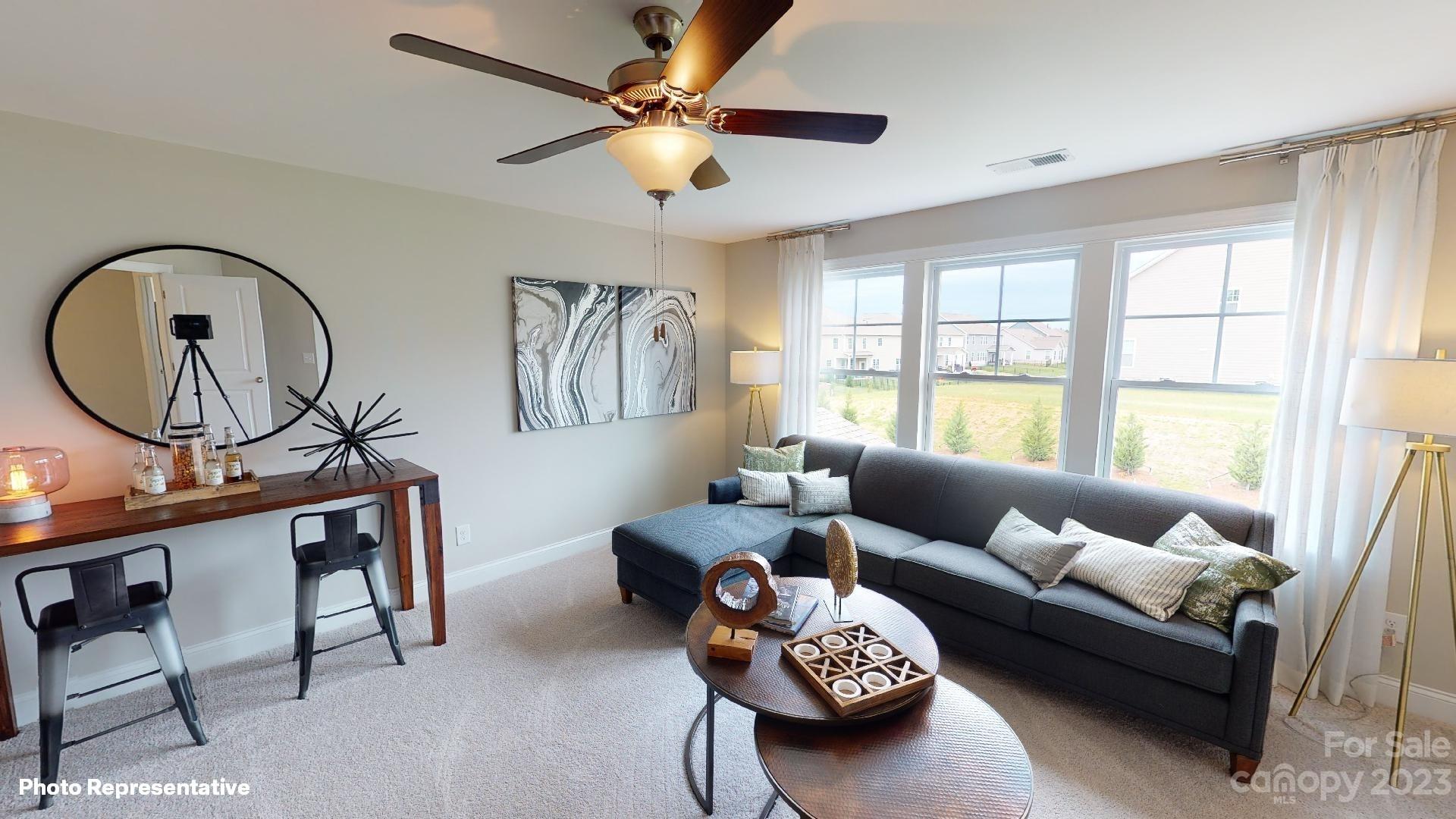 384 Streamwood Road Troutman, NC 28166 - Photo 25 of 36 a living room with furniture and a large window