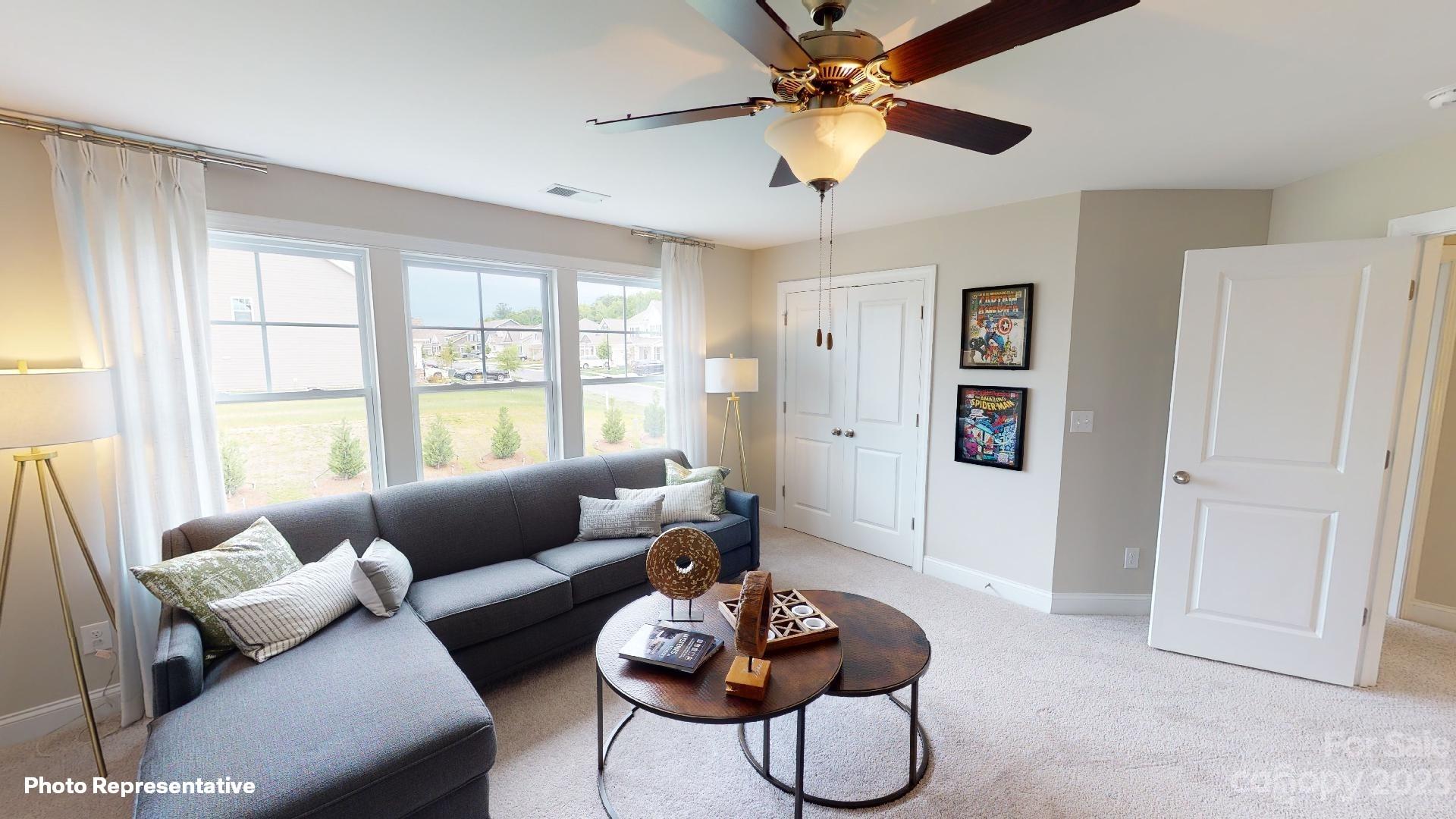 384 Streamwood Road Troutman, NC 28166 - Photo 26 of 36 a living room with furniture and a large window