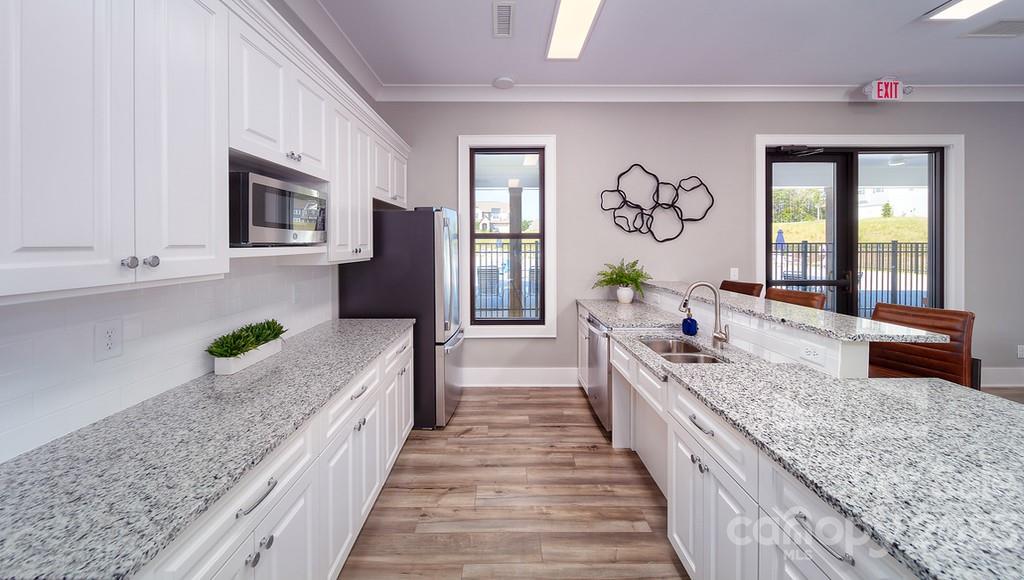 384 Streamwood Road Troutman, NC 28166 - Photo 30 of 36 a large spacious bathroom with a granite countertop sink and a bathtub