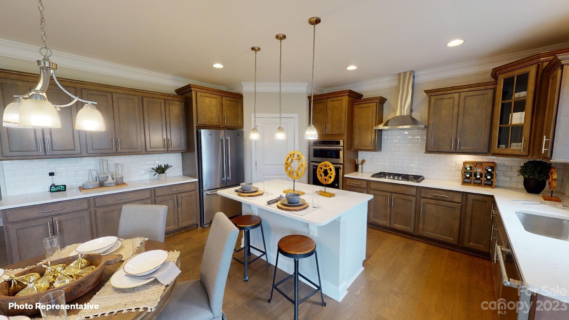 384 Streamwood Road Troutman, NC 28166 - Photo 3 of 36 a kitchen that has a table and chairs in it