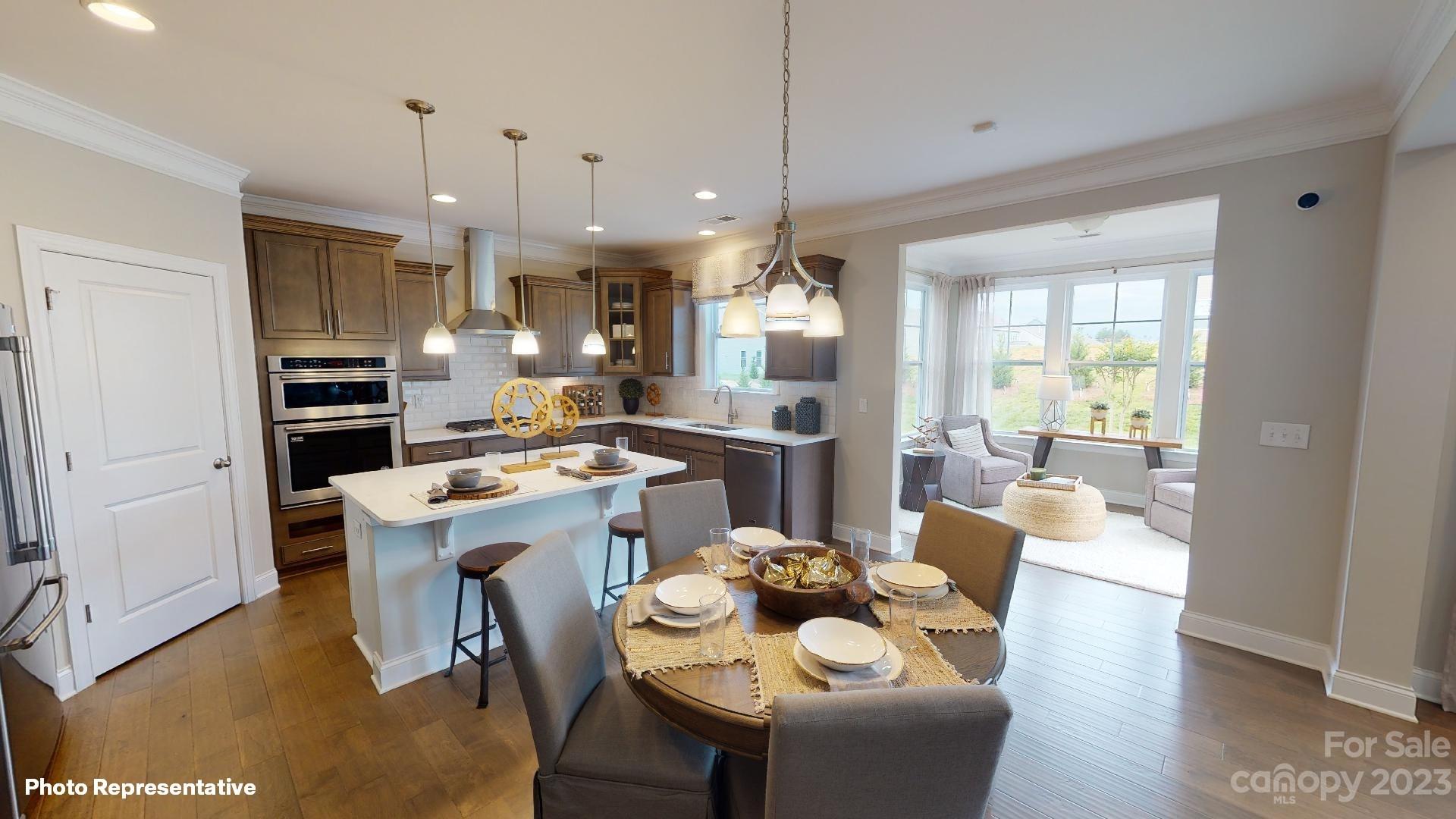 384 Streamwood Road Troutman, NC 28166 - Photo 5 of 36 a large kitchen with a table and chairs