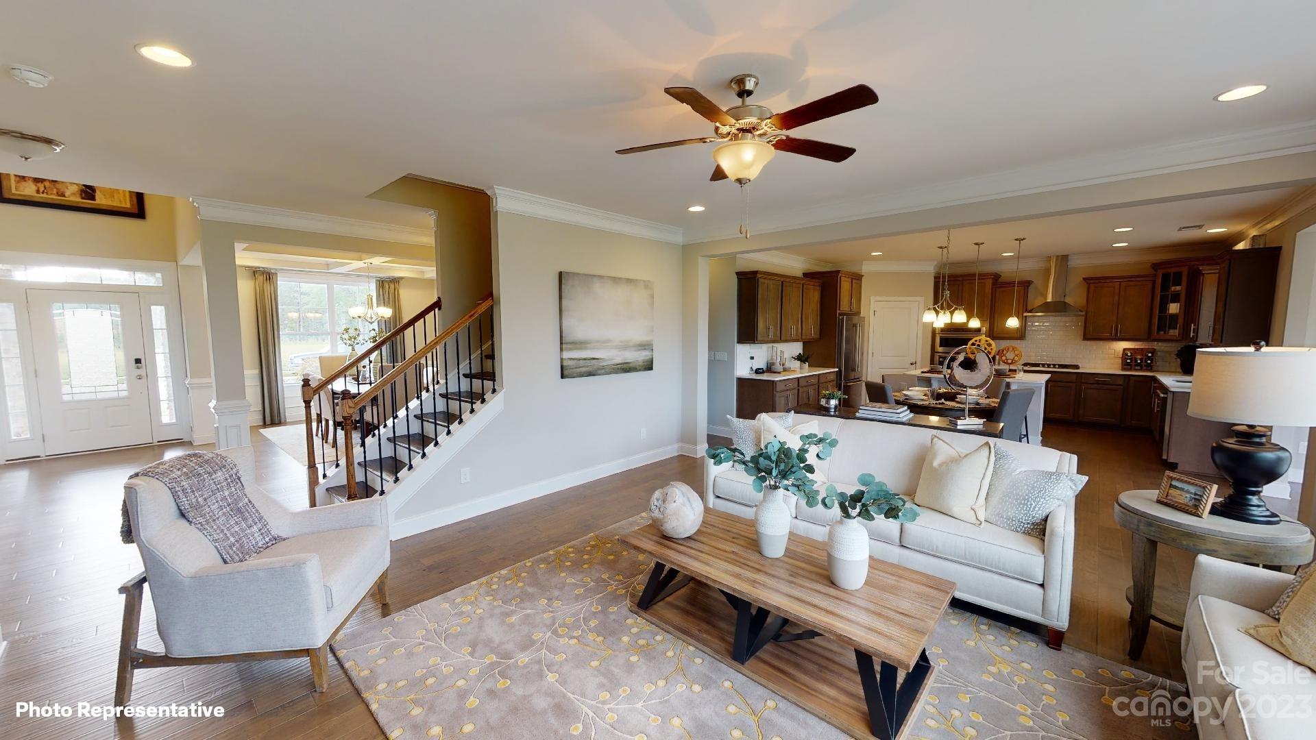 384 Streamwood Road Troutman, NC 28166 - Photo 6 of 36 a living room with furniture and kitchen view