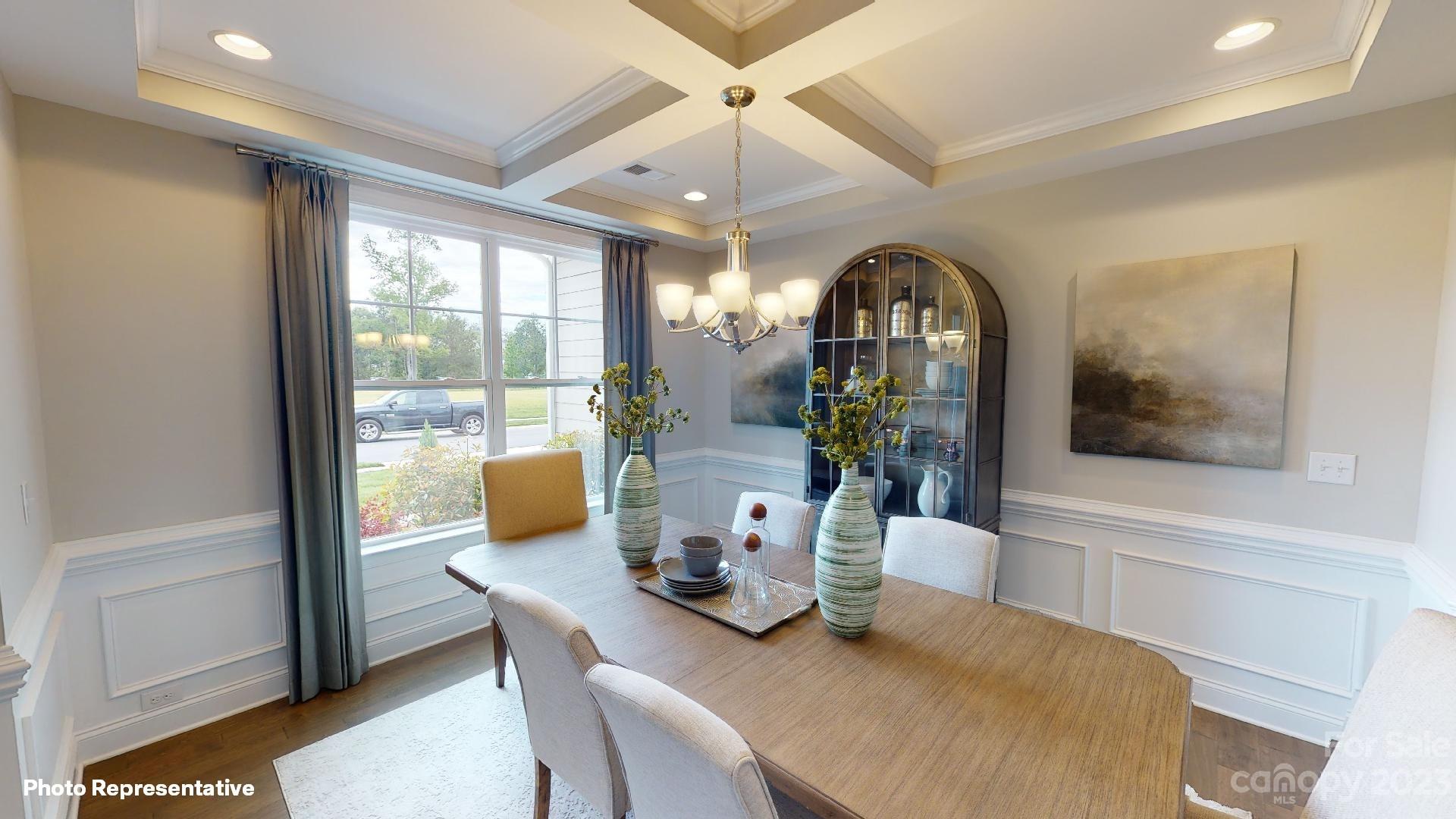384 Streamwood Road Troutman, NC 28166 - Photo 10 of 36 a view of a dining room with furniture a chandelier and wooden floor