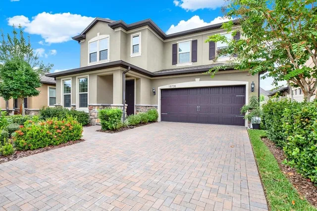 a front view of a house with a yard and garage
