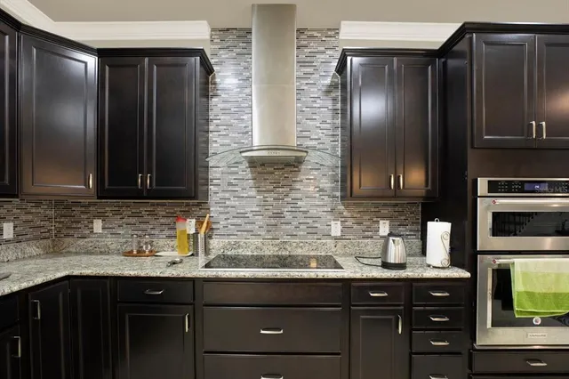a kitchen with stainless steel appliances granite countertop a refrigerator and a sink