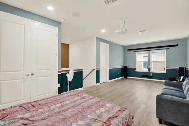 a bedroom with a large bed and a couch