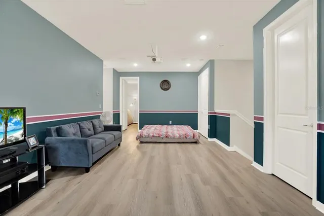 a spacious bedroom with a bed and a couch