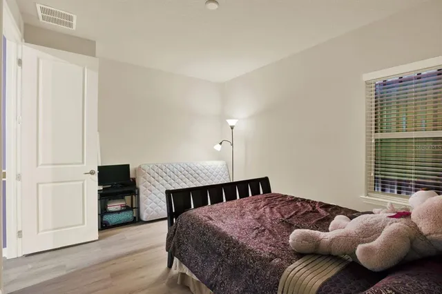 a bedroom with a bed a fireplace and a window