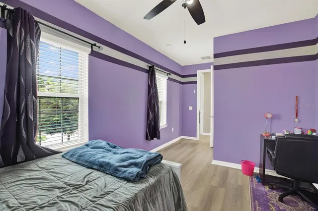 a bedroom with a bed dresser and a window