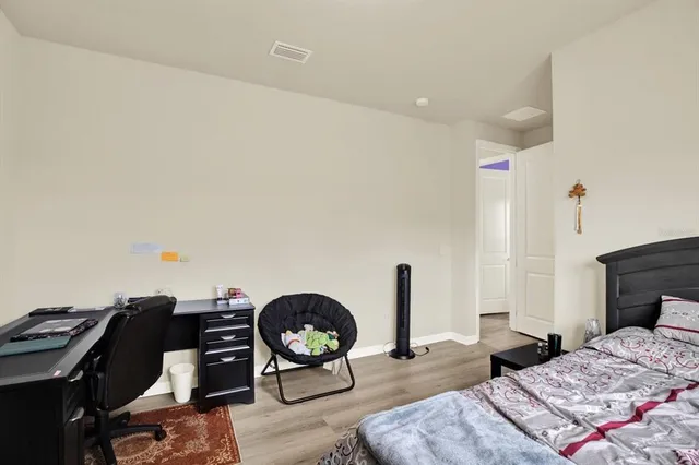 a bedroom with a bed and dresser