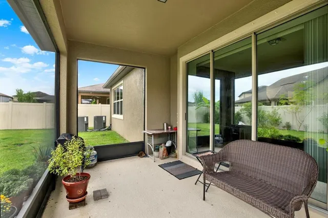 a balcony with furniture and garden view