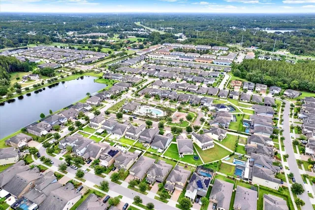 an aerial view of residential houses with city view
