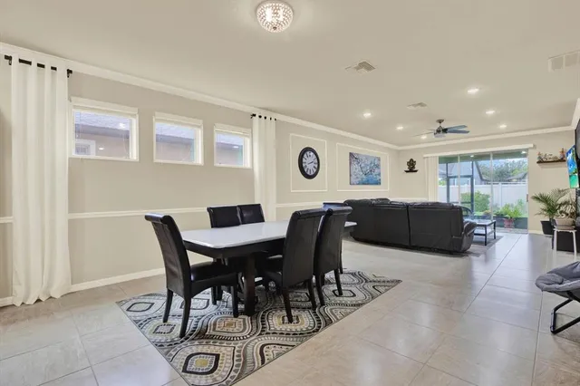 a view of a dining room with furniture and a large window