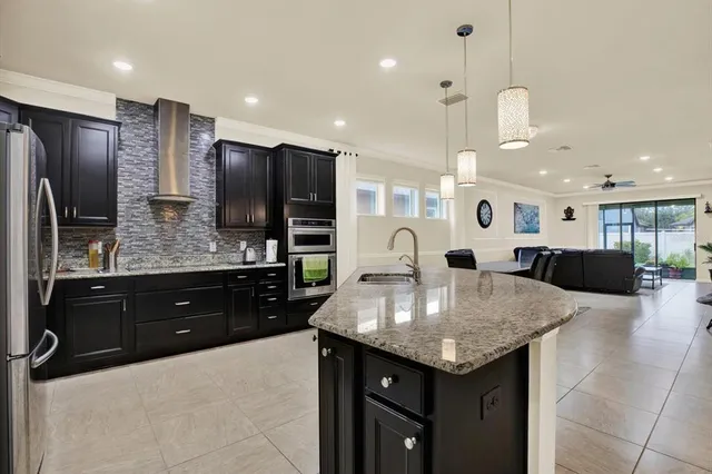 a kitchen with stainless steel appliances granite countertop a sink counter space and refrigerator