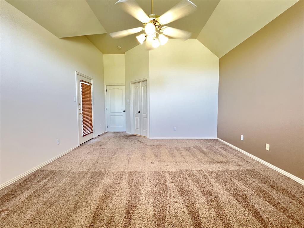 7517 Rodeo Drive Denton, TX 76208 - Photo 14 of 30 a view of a big room with closet and a ceiling fan