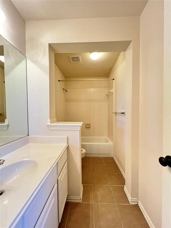 7517 Rodeo Drive Denton, TX 76208 - Photo 23 of 30 a bathroom with a tub sink and mirror
