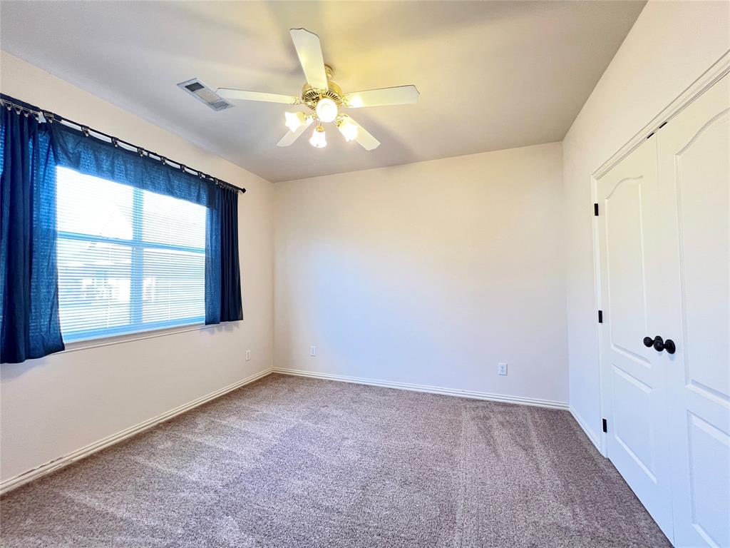 7517 Rodeo Drive Denton, TX 76208 - Photo 25 of 30 wooden floor in an empty room with a window