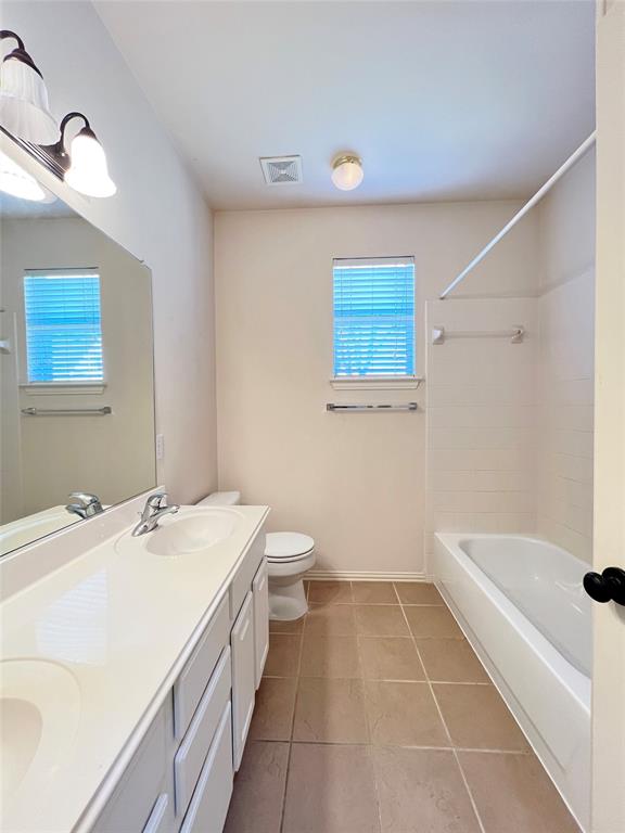 7517 Rodeo Drive Denton, TX 76208 - Photo 27 of 30 a bathroom with a sink a toilet and shower