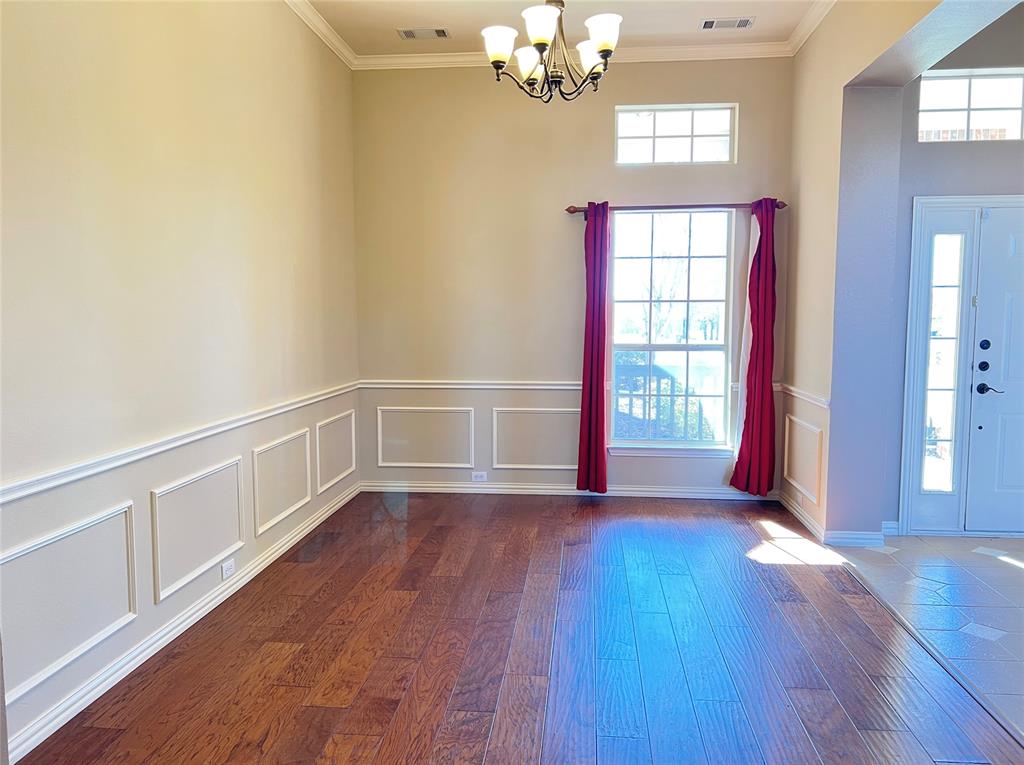 7517 Rodeo Drive Denton, TX 76208 - Photo 3 of 30 a view of an empty room with wooden floor and a window