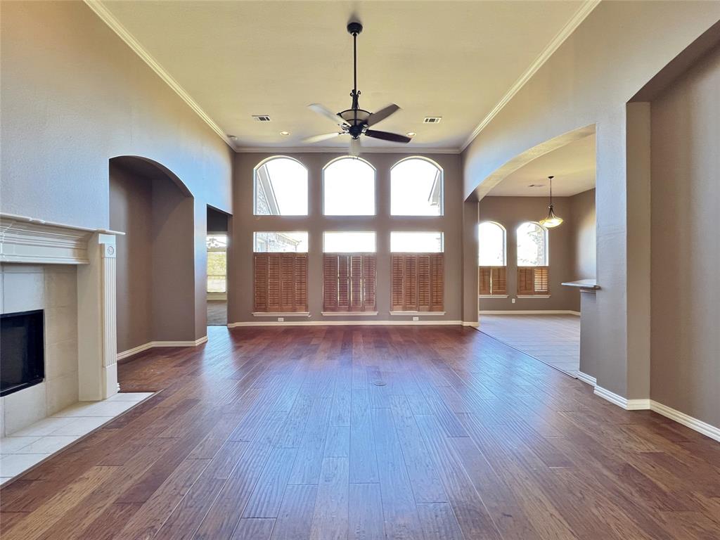 7517 Rodeo Drive Denton, TX 76208 - Photo 6 of 30 a view of an empty room with a window and wooden floor