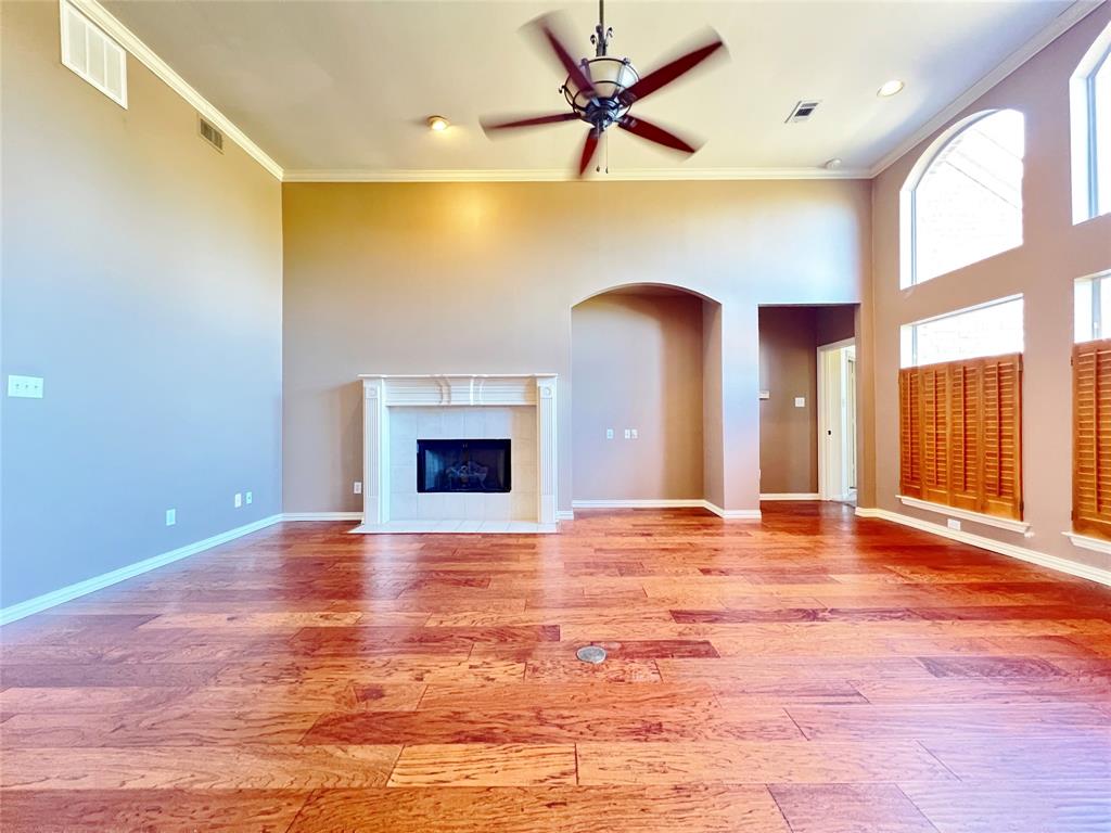 7517 Rodeo Drive Denton, TX 76208 - Photo 7 of 30 a view of an empty room with window and wooden floor