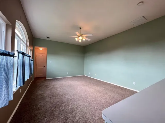 wooden floor in an empty room with a chandelier