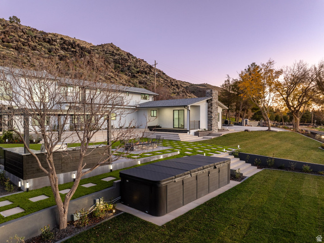 476 Spring Drive Toquerville, UT 84774 - Photo 84 of 95 Back of house with a patio area, a lawn, stucco siding, a mountain view, and a hot tub