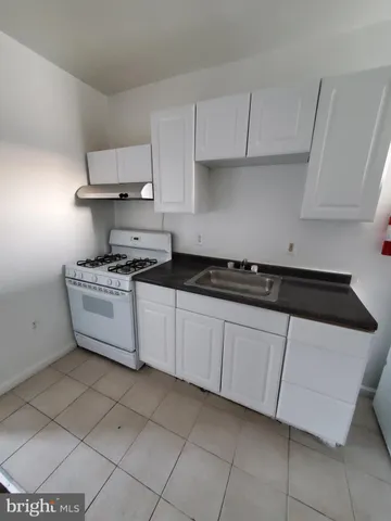 a kitchen with cabinets and white appliances
