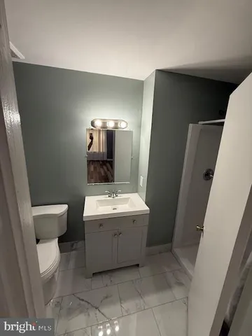 a view of bathroom with a toilet sink and mirror
