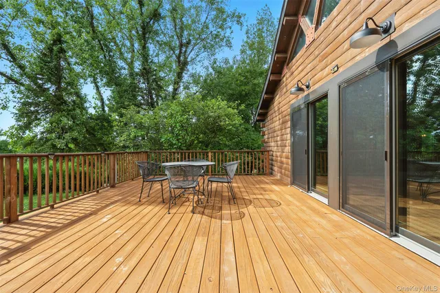 a view of backyard with a deck and wooden floor