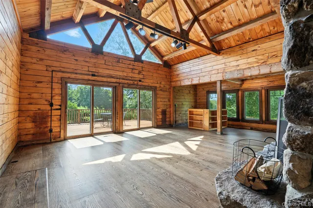 a view of a backyard with wooden floor and iron fence