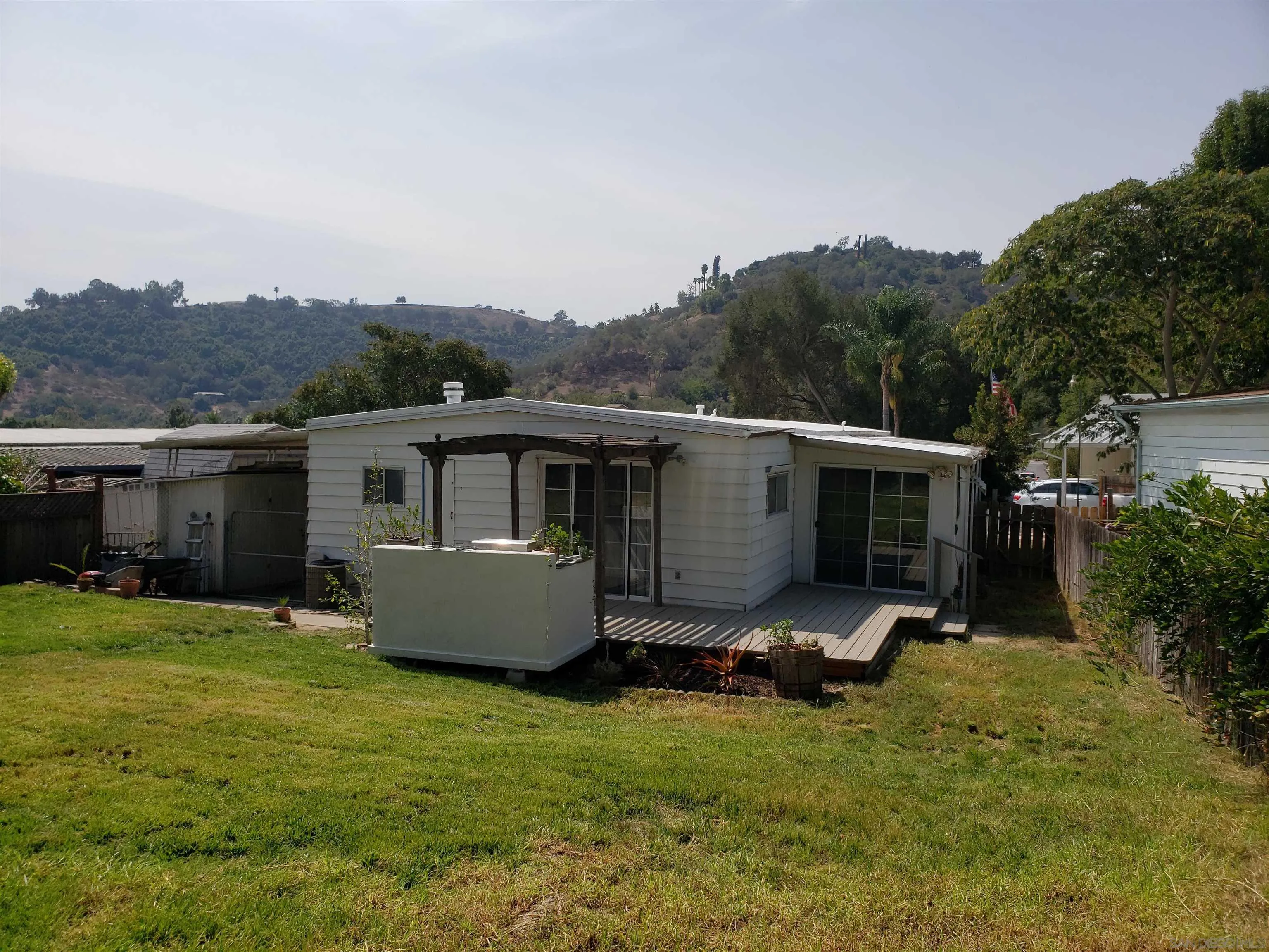 3909 Reche Road, Unit 97 Fallbrook, CA 92028 - Photo 5 of 18 an outdoor sitting area with furniture and garden
