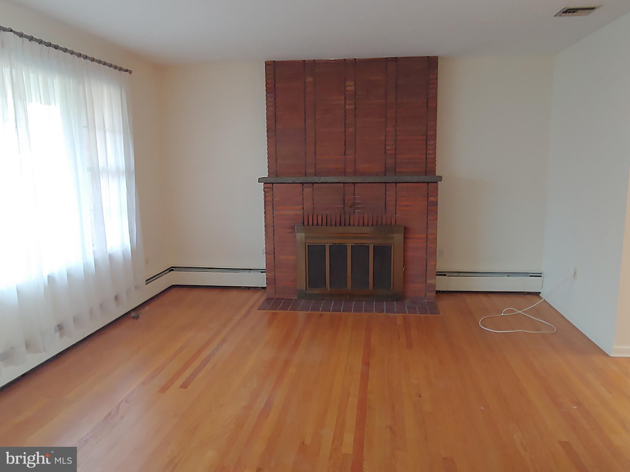 1128 Hagues Mill Road Ambler, PA 19002 - Photo 13 of 25 Living Room w/ Brick Fireplace