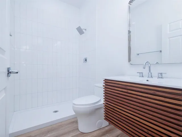 a bathroom with a sink toilet and shower