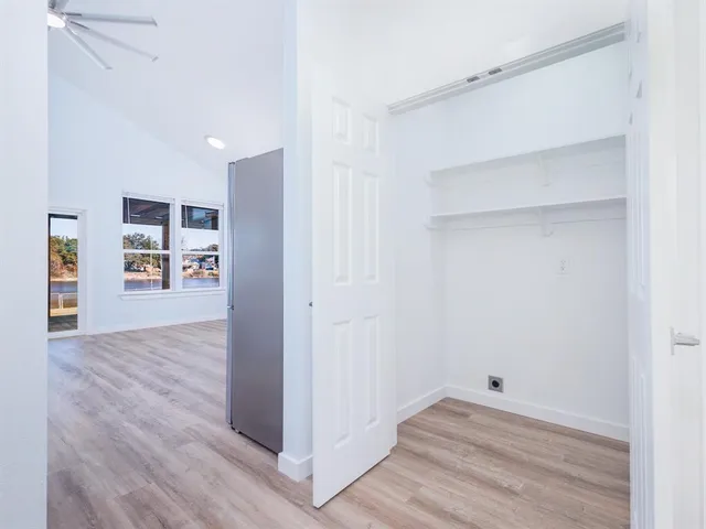 a view of empty room with wooden floor and closet