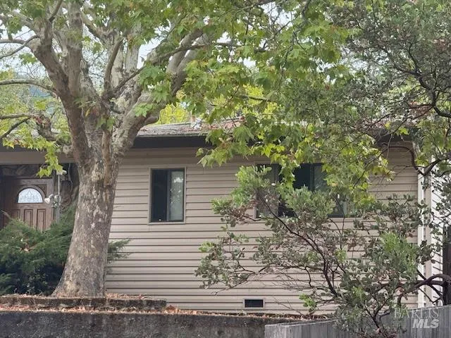 a front view of a house with trees
