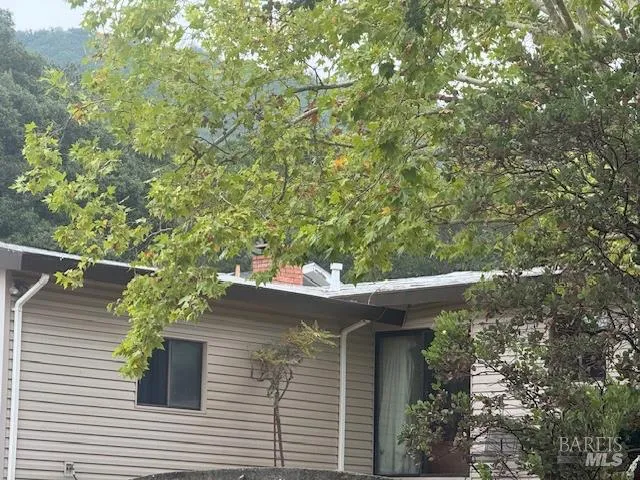 a view of a house with a tree