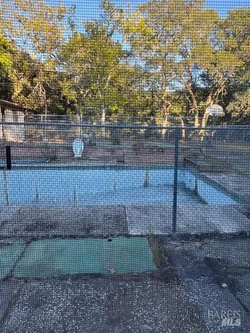 a view of a yard with wooden fence