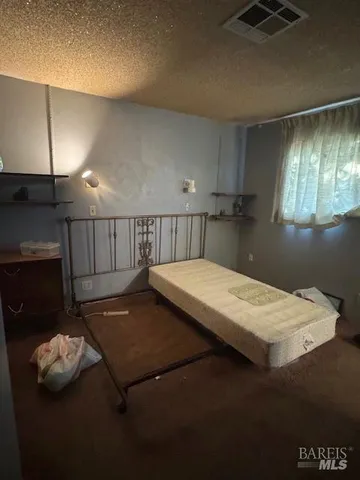 a bed sitting in a room next to a window