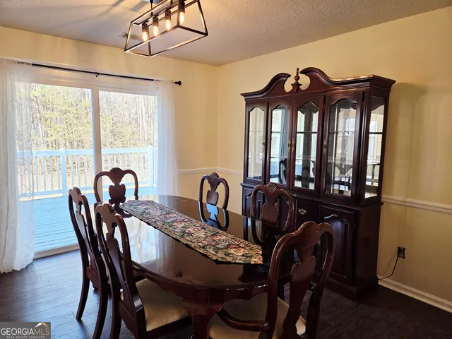 a view of a dining room with furniture window and outside view
