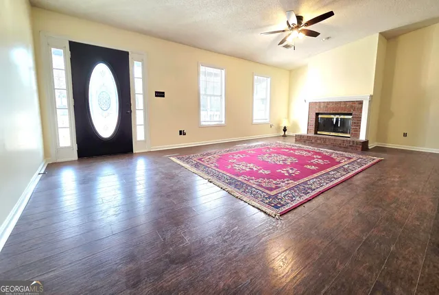 a living room with a bed furniture and a window